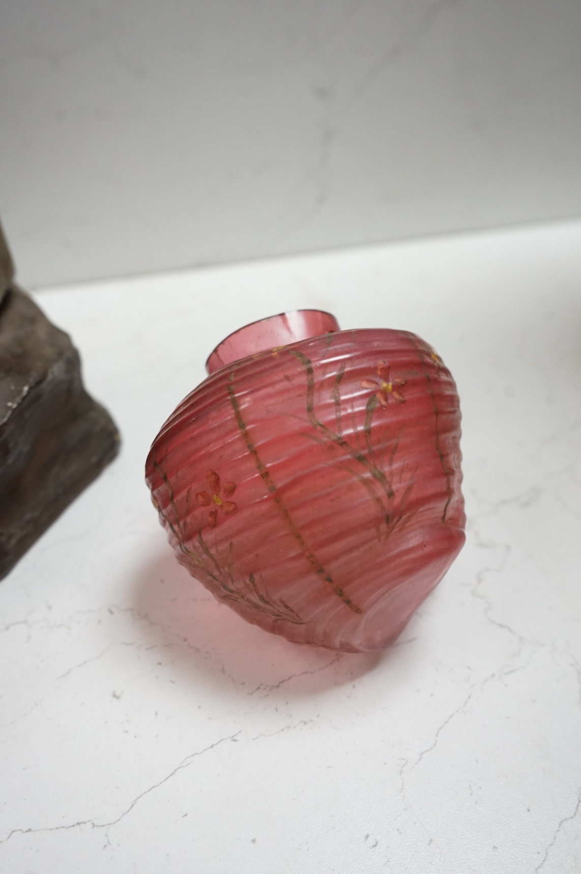 A Goldscheider cold-painted terracotta figural lamp with two cranberry glass shades, 55cm high